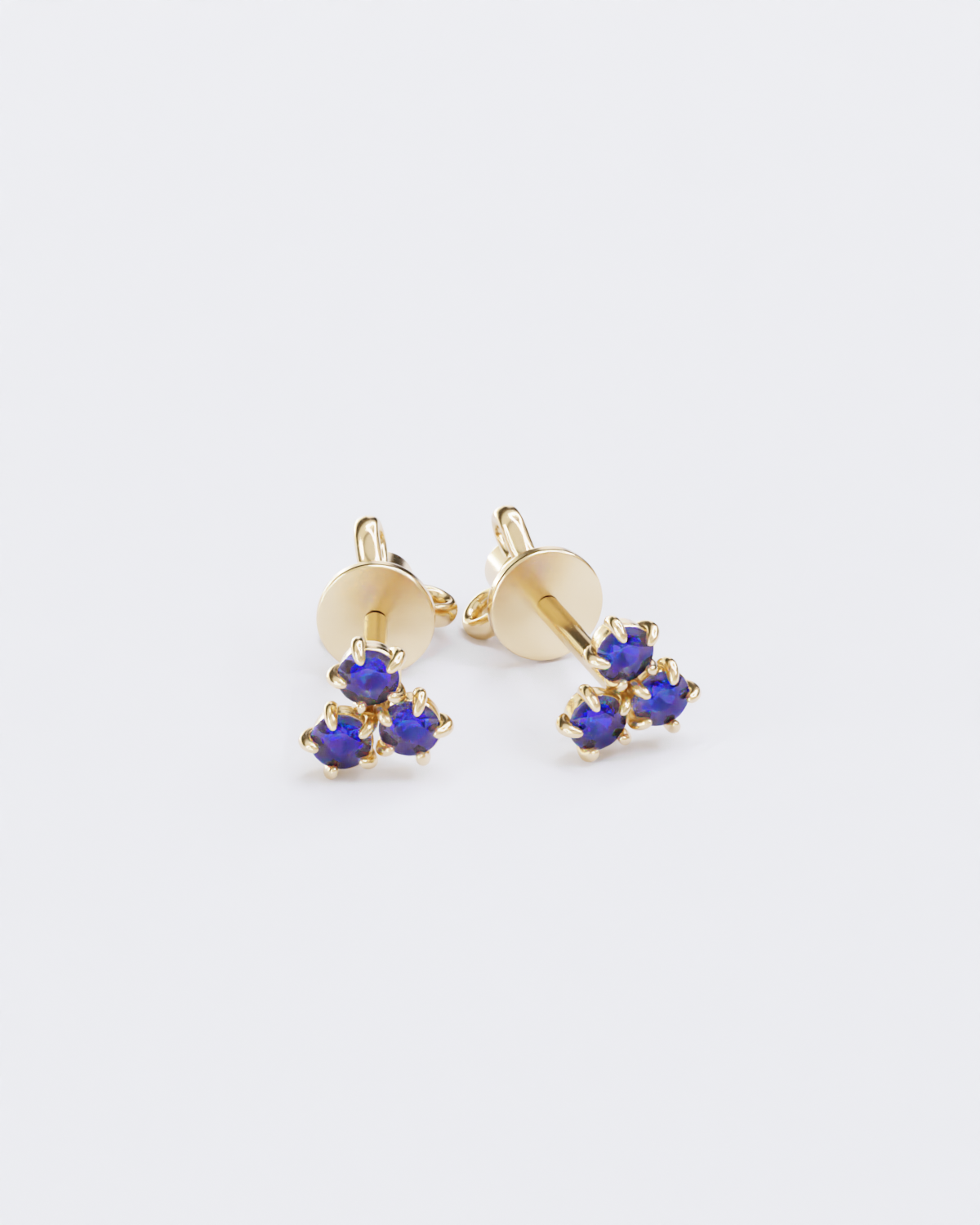 Gold piercing studs with sapphires