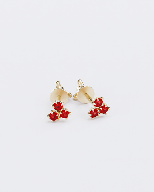 Gold piercing studs with rubies